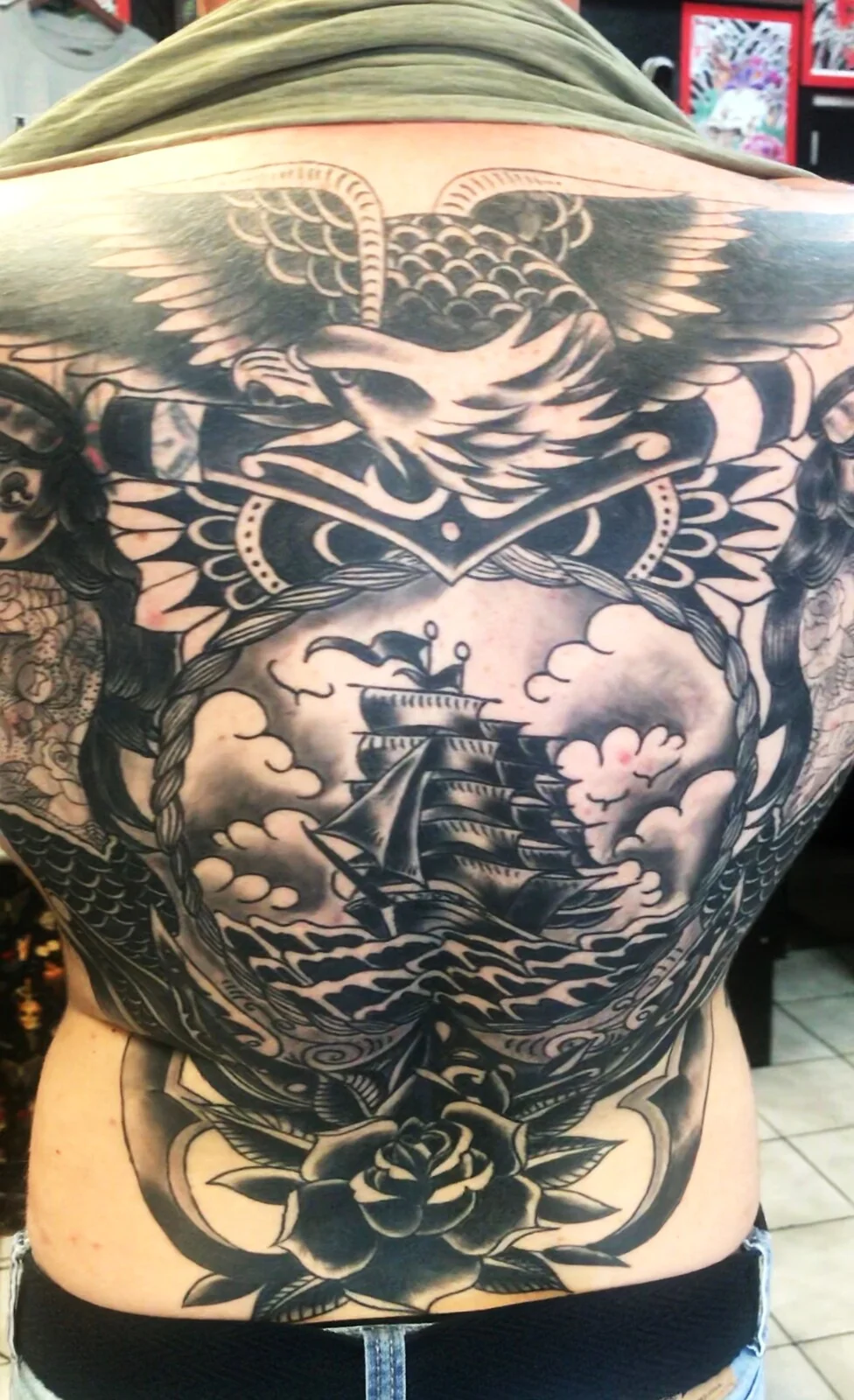 Black and grey traditional eagle and clipper ship full backpiece tattoo by Tim Goodrich, Waikiki, Hawaii