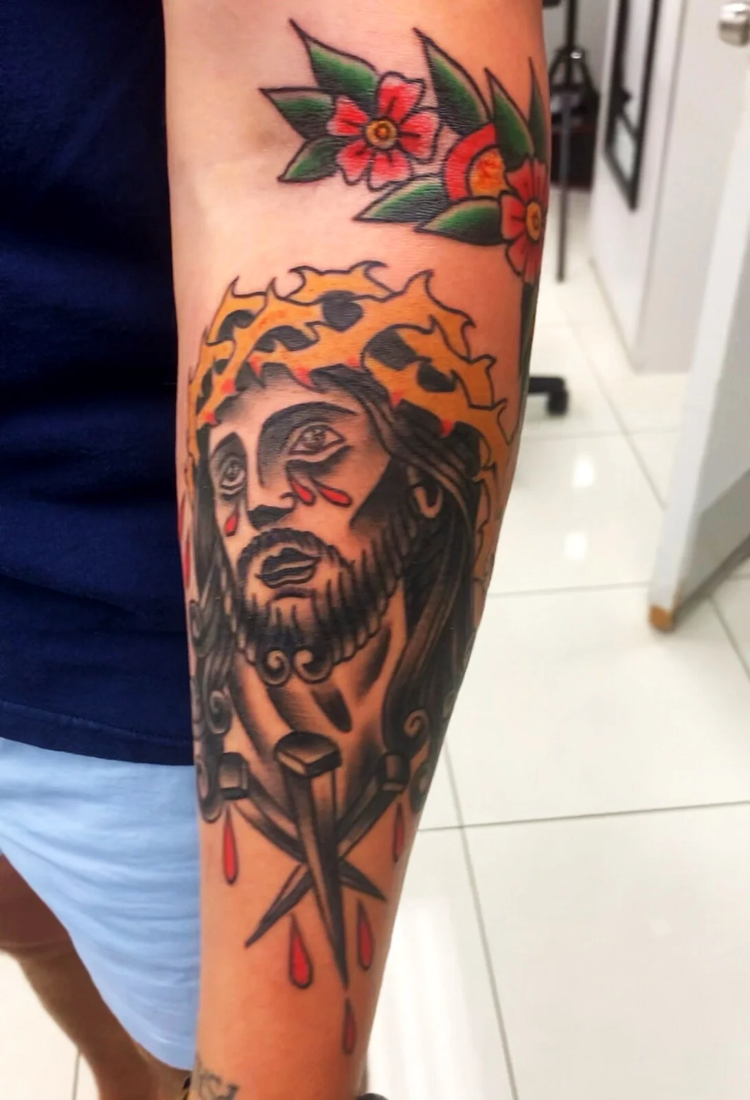 American Traditional Jesus with crown of thorns and dripping blood forearm tattoo by Tim Goodrich, Waikiki, Hawaii