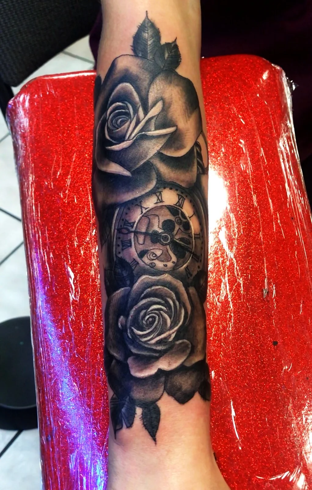 Black and grey realism roses with pocket watch forearm tattoo by Tim Goodrich, Waikiki, Hawaii