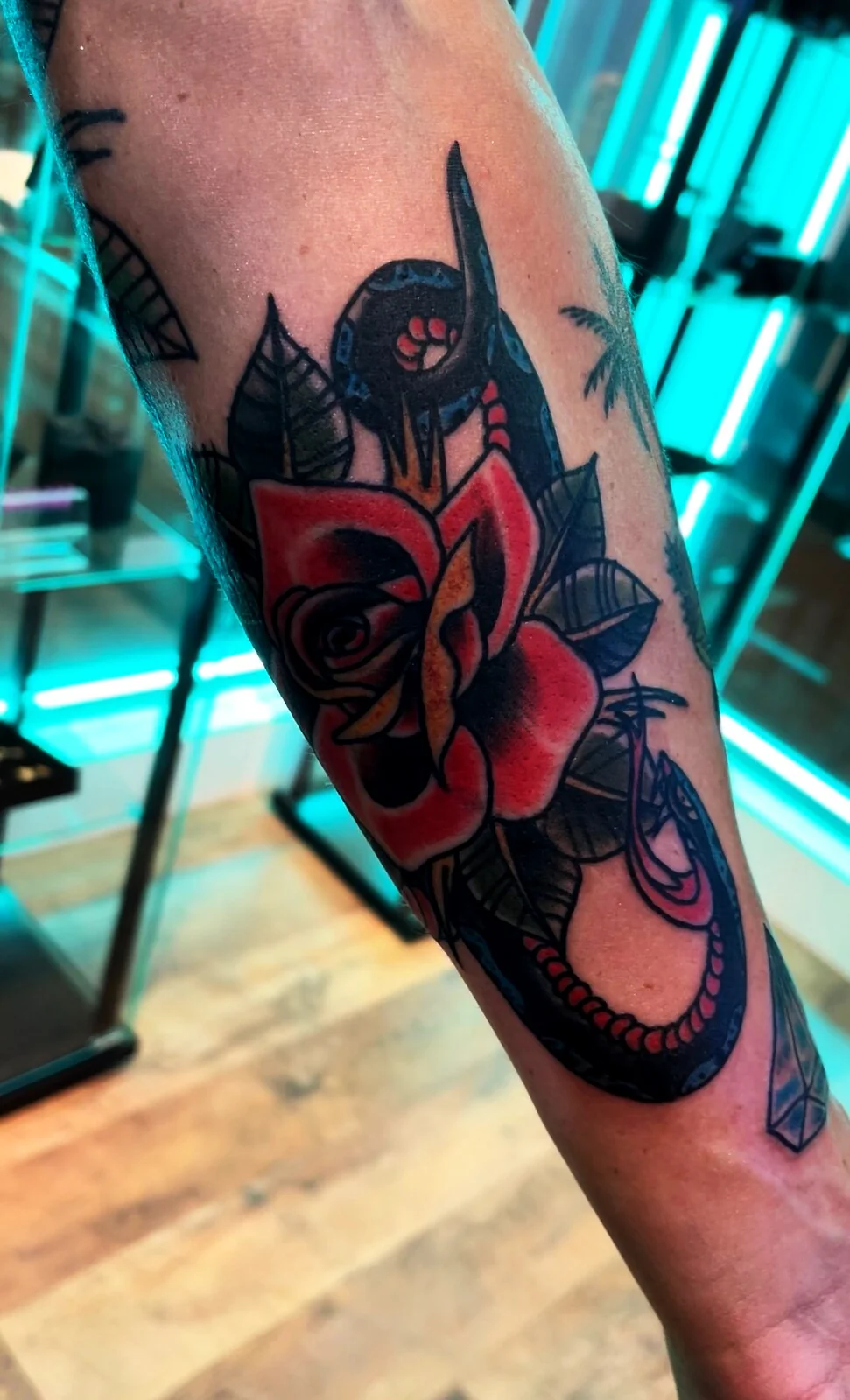American Traditional rose, snake and horseshoe forearm tattoo by Tim Goodrich, Waikiki, Hawaii